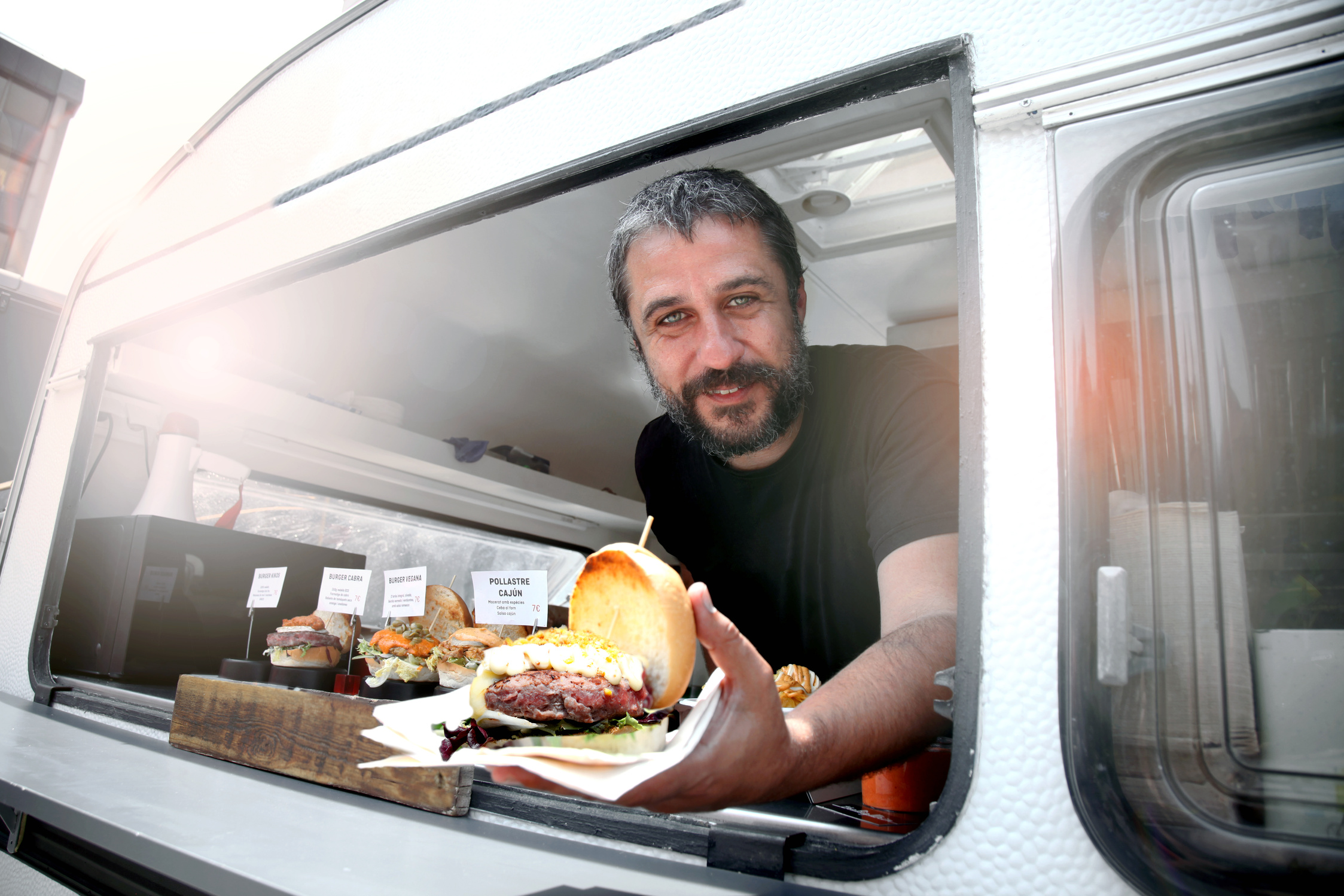 Food truck owner serving burger